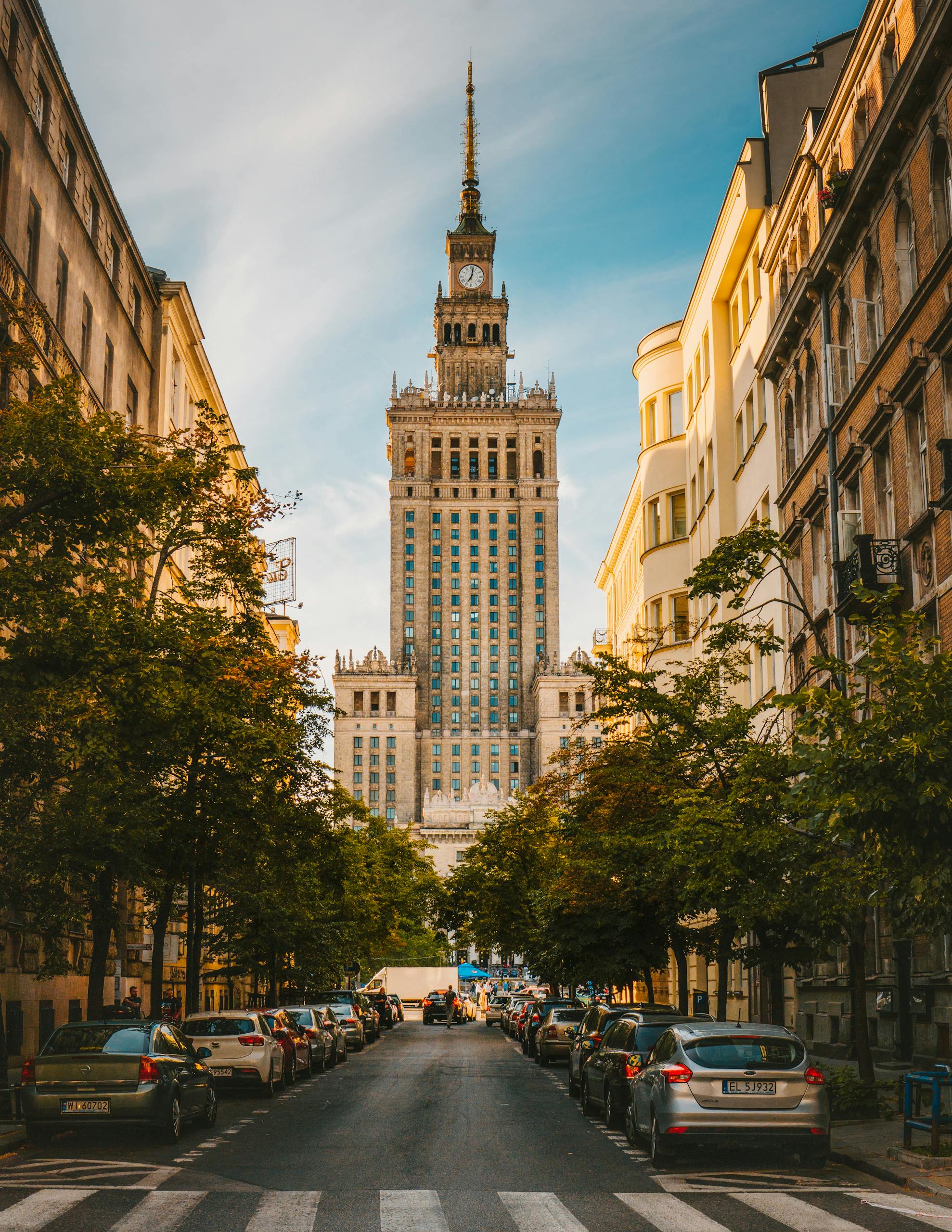 A vibrant street view of the Palace of Culture and Science in Warsaw, showcasing urban architecture.