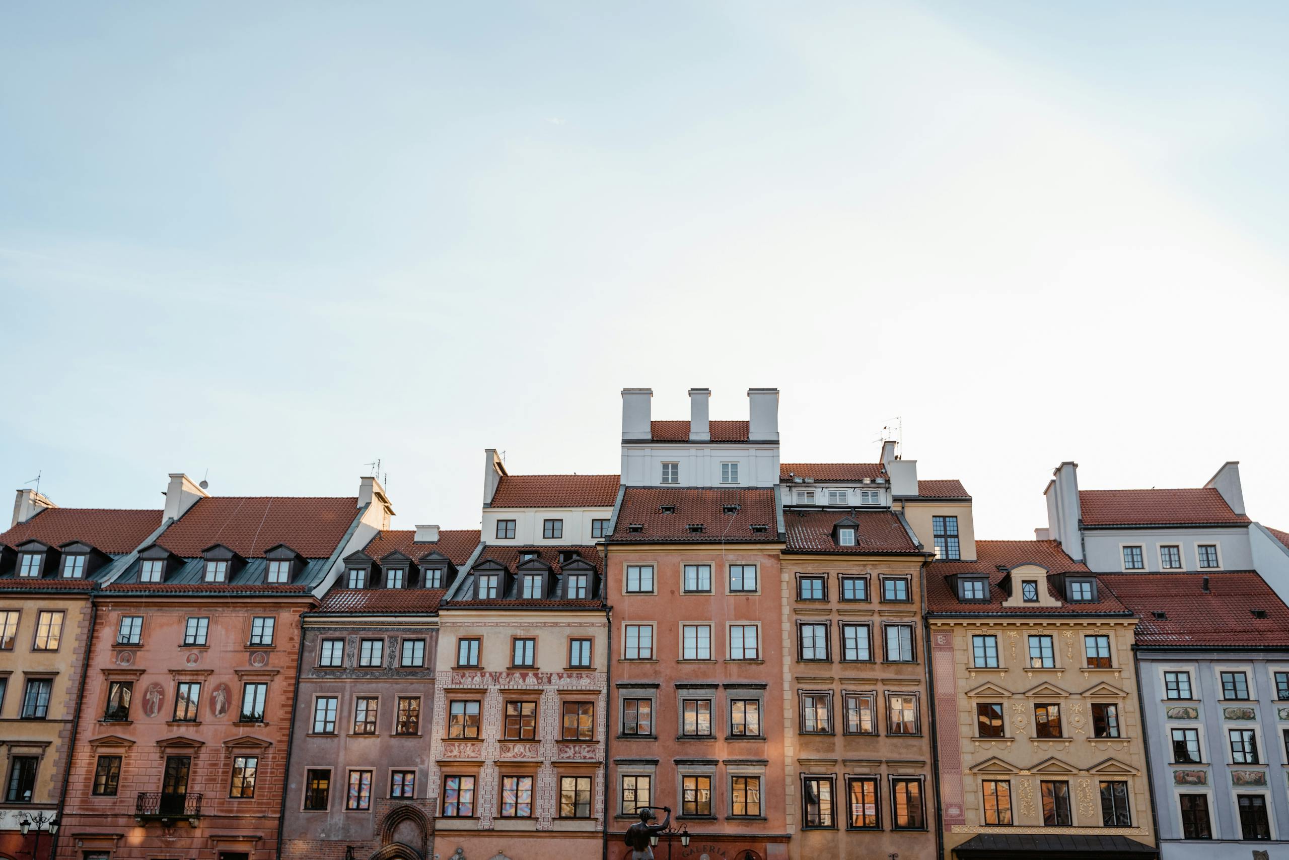 Charming facades of historic European buildings under clear sky, showcasing classic architecture.