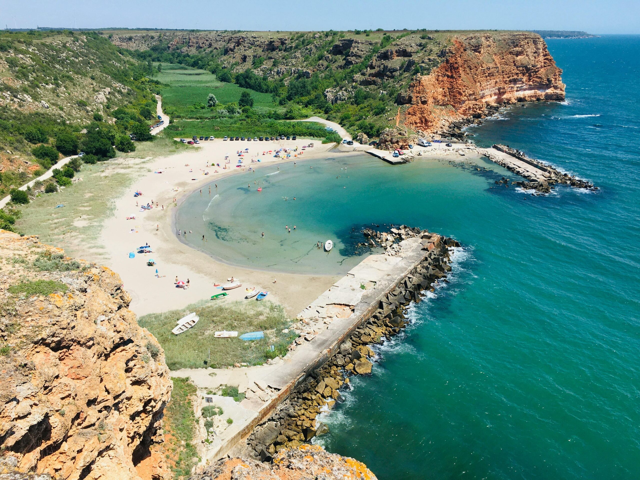 Bułgaria wybrzeże skalne zatoczka z drona - czerwone klify z chronioną plażą i turkusową wodą Morze Czarne, unikalna lokalizacja nieruchomości na klifach, ekskluzywne właściwości cliff-top access plaża